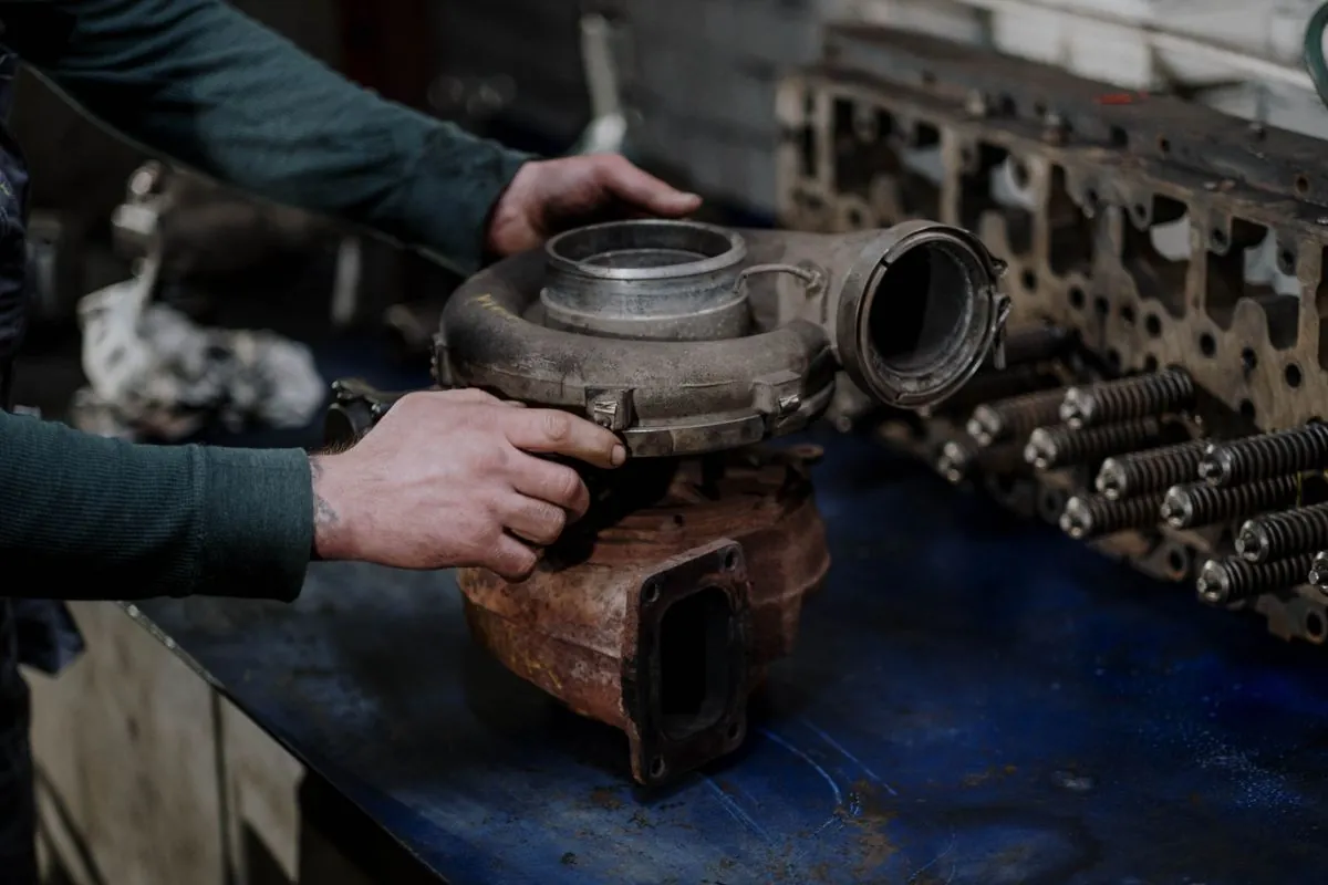 Engineer inspecting a marine engine component